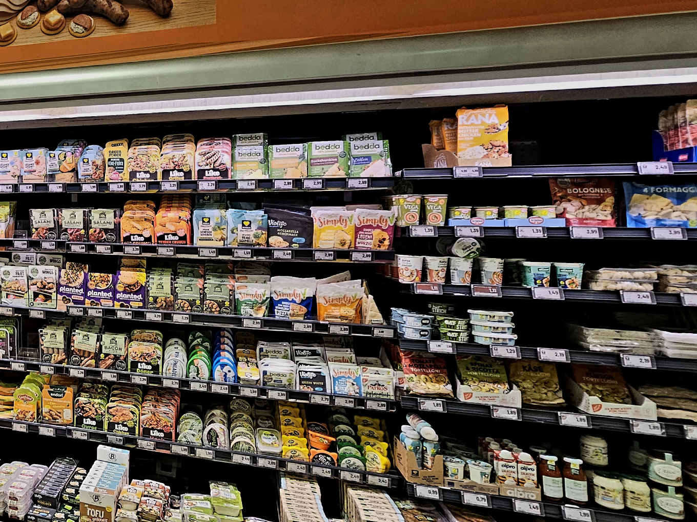 Verschiedene Produkte im Supermarktregal unter Beleuchtung, ordentlich arrangiert