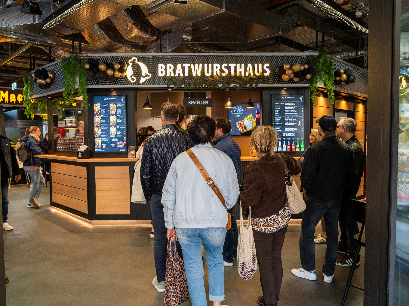 Kunden stehen Schlange im Bratwursthaus
